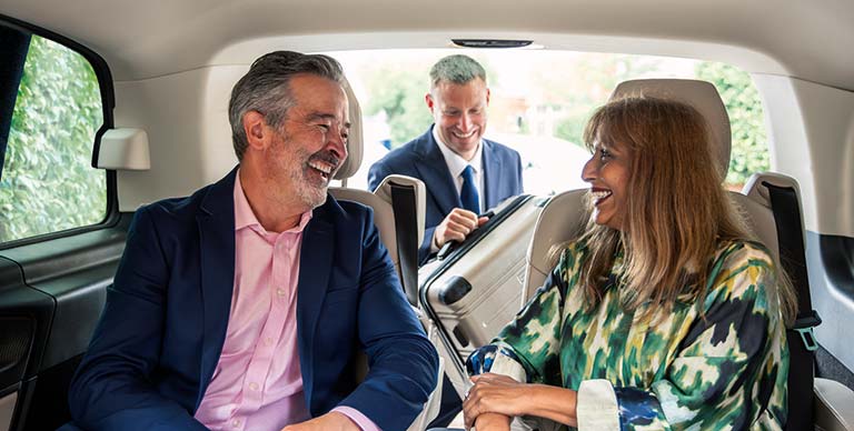 A couple being collected by their chauffeur